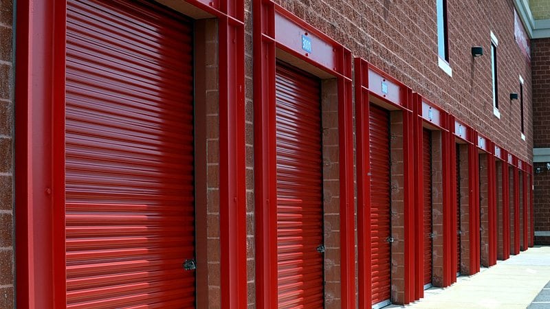 A row of red storage facilities, securely closed and locked